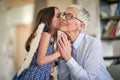 Granddaughter kissing grandmother in the cheek