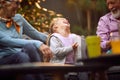 Granddaughter laughing out loud with her grandparents, having wonderful time