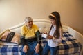 Granddaughter measures her grandmother`s blood pressure at home