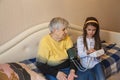 Granddaughter measures her grandmother`s blood pressure at home