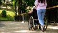 Granddaughter pushing old woman in wheelchair hospital garden, support and care Royalty Free Stock Photo