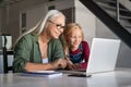 Granddaughter and senior woman using laptop Royalty Free Stock Photo