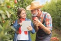 Granddaughter showing grandfather how to use tablet