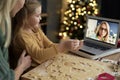 Granddaughter showing her grandma Christmas cookies during a video conference Royalty Free Stock Photo