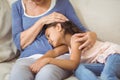 Granddaughter sleeping on grandmothers lap in living room Royalty Free Stock Photo