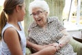 Granddaughter Visiting Grandmother In Lounge Of Retirement Home