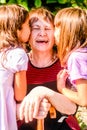 Granddaughters kissing their old Grandmother Royalty Free Stock Photo