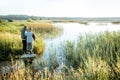 Grandfather with adult son fishing on the lake Royalty Free Stock Photo