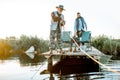 Grandfather with adult son fishing on the lake Royalty Free Stock Photo