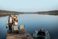 Grandfather with adult son fishing on the lake Royalty Free Stock Photo