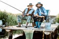 Grandfather with adult son fishing on the lake Royalty Free Stock Photo