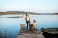 Grandfather with adult son talking on fishing Royalty Free Stock Photo