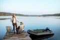 Grandfather with adult son talking on fishing Royalty Free Stock Photo