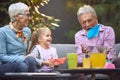 Grandfather amusing his granddaughter, telling story, throwing up and down paper boat Royalty Free Stock Photo