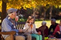 Grandfather blowing bubbles with granddaughter Royalty Free Stock Photo