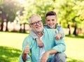 Grandfather and boy showing thumbs up at summer Royalty Free Stock Photo