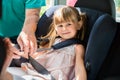 Grandfather Buckling Up On Granddaughter In Car Safety Seat Royalty Free Stock Photo