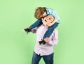 Grandfather carries grandson on shoulders on green background isolated. Men generation, Royalty Free Stock Photo