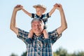 Grandfather carries grandson toddler boy on his shoulders Royalty Free Stock Photo