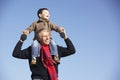 Grandfather Carrying Grandson On His Shoulders Royalty Free Stock Photo