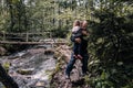 Grandfather Carrying His Granddaughter in His Arms on Muddy Road Royalty Free Stock Photo