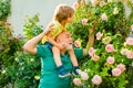 Grandfather carrying his grandson having fun in the park at the summer time. Child with Grandfather dreams in summer in Royalty Free Stock Photo