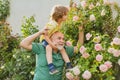 Grandfather carrying his grandson having fun in the park at the summer time. Father giving son ride on back in park Royalty Free Stock Photo