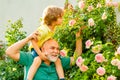 Grandfather carrying his grandson having fun in the park at the summer time. Happy grandfather giving grandson piggyback Royalty Free Stock Photo