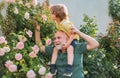 Grandfather carrying his grandson having fun in the park at the summer time. Happy grandfather and grandson relaxing Royalty Free Stock Photo