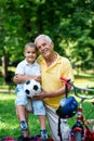 Grandfather and child have fun in park Royalty Free Stock Photo