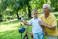 Grandfather and child have fun in park Royalty Free Stock Photo