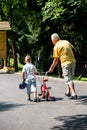 Grandfather and child have fun in park Royalty Free Stock Photo