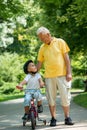 Grandfather and child have fun in park Royalty Free Stock Photo