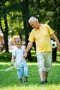 Grandfather and child have fun in park Royalty Free Stock Photo