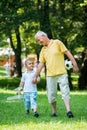 Grandfather and child have fun in park Royalty Free Stock Photo