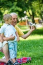 Grandfather and child have fun in park Royalty Free Stock Photo