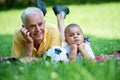 Grandfather and child have fun in park Royalty Free Stock Photo