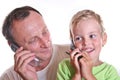 Grandfather and child with phones