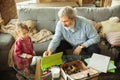 Grandfather and child playing together at home. Happiness, family, relathionship, education concept.