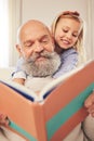 Grandfather, child and reading a story book in a family home for fun, happiness and learning. A senior man or grandpa Royalty Free Stock Photo