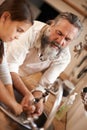 Grandfather, child and washing hands with water for hygiene in kitchen, skincare and health. Mature man, grandchild and