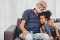 Grandfather embraces hug love for the little girl niece in a warm family home Royalty Free Stock Photo