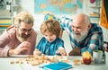 Grandfather father and cute little son having fun at home. Parenting childhood values weekend. Male multi generation Royalty Free Stock Photo