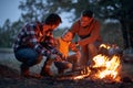 Grandfather, father and son camping together; Spring or autumn camping with campfire at night ; camping, travel, tourism, hike and Royalty Free Stock Photo