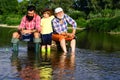 Grandfather, father and son are fly fishing on river. Man in different ages. Royalty Free Stock Photo