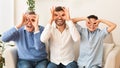 Grandfather, Father And Son Holding Fingers Near Eyes Sitting Indoor Royalty Free Stock Photo