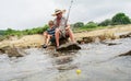 Grandfather fisher in straw hat and little male grandkid enjoying leisure activity use fishing rod Royalty Free Stock Photo