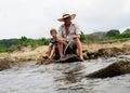 Grandfather fisher in straw hat and little male grandkid enjoying leisure activity use fishing rod Royalty Free Stock Photo