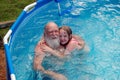 Grandfather and girl in pool