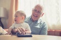 Grandfather with grandchild at table using tablet Royalty Free Stock Photo